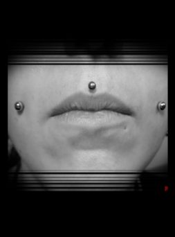 closeup of person with double cheek piercing