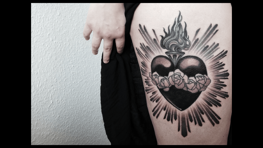 thigh tattoo of heart and flames
