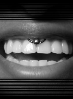 person smiling with smiley piercing